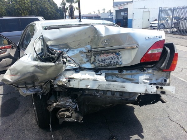 Taitz accident photo showing extensive rear end damage